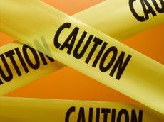 yellow caution tape with word caution written in large black letters