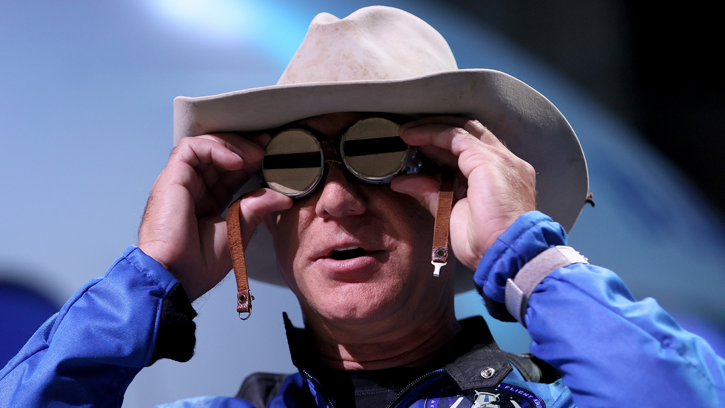 Bezos shows the aviation glasses that once belonged to Amelia Earhart, which he took with him during the flight, at the post-flight press conference.