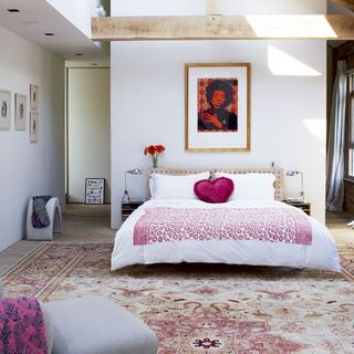 white bedroom with wall painting and carpet