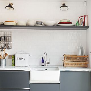 kitchen with white wall tiles and drawers