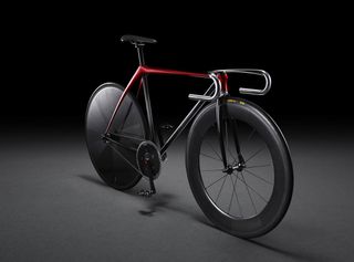 View of a black and red bicycle pictured against a black background