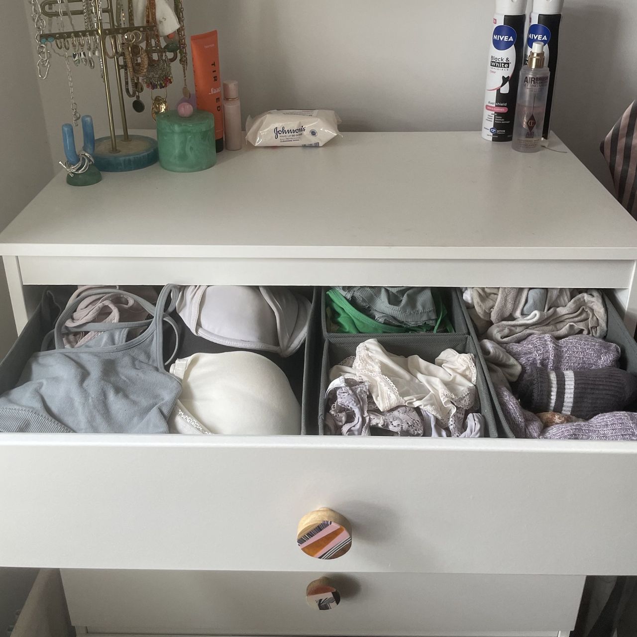 White chest of drawers with underwear in grey drawer organisers