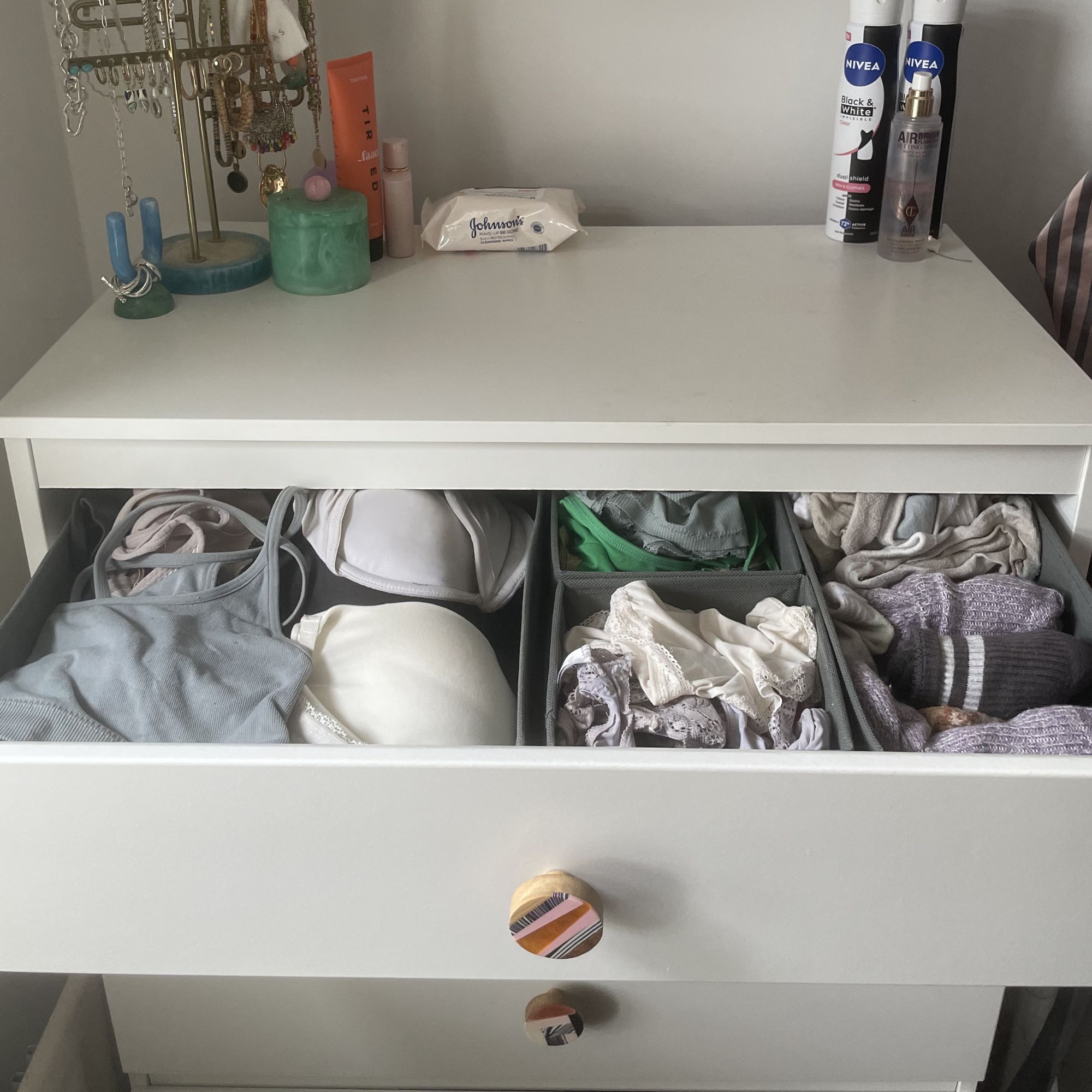White chest of drawers with underwear in grey drawer organisers 