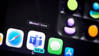 Microsoft Teams app and logo running on a laptop and smartphone.