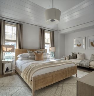 neutral bedroom with rattan bed and drapery by Brad Ramsey Interiors