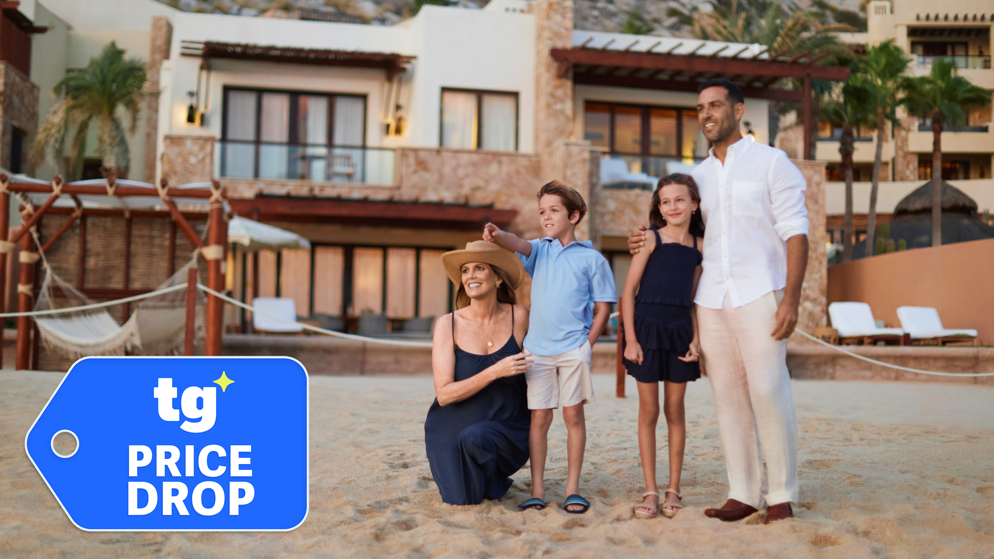 A family of four standing on the beach outside a hotel