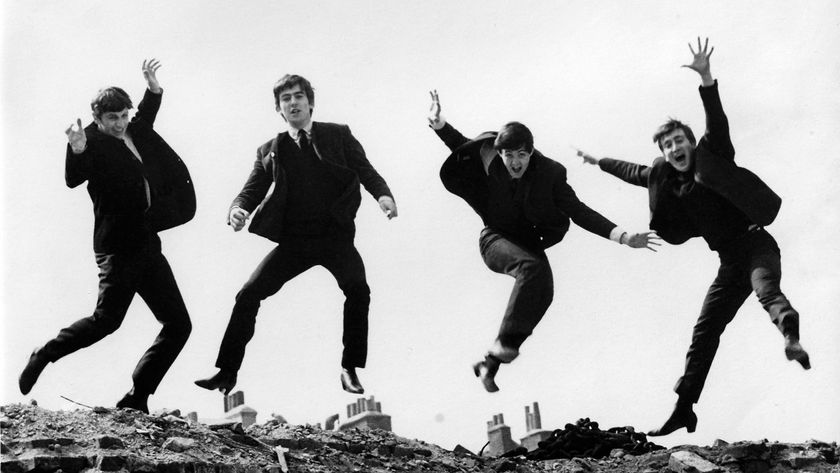 A black and white photo of all four members of The Beatles jumping in air