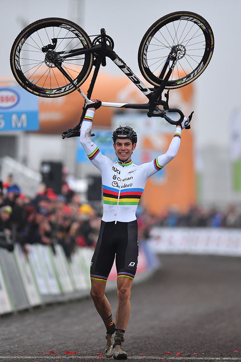 Wout Van Aert lifts his bike over his head