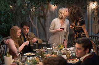 the moms on the tv show the fosters kiss at the head of the table at a big dinner in the fosters