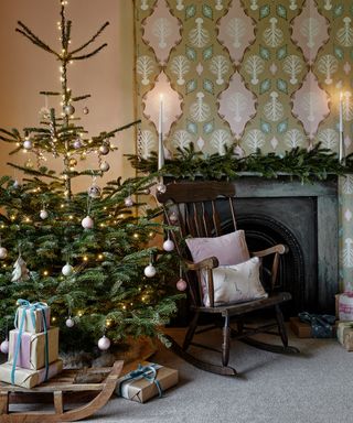 Christmas tree beside a rocking chair and victorian fireplace