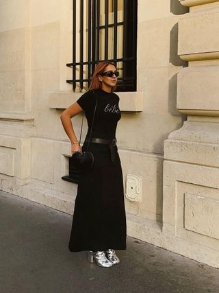 woman wearing black maxi skirt with silver ankle boots and black t-shirt