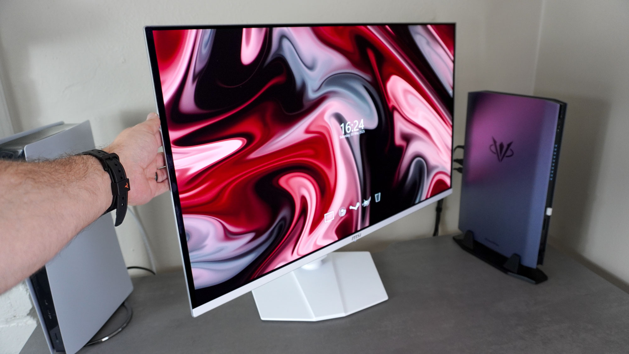 Tilting the MSI MPG 321URXW QD-OLED monitor on its included stand