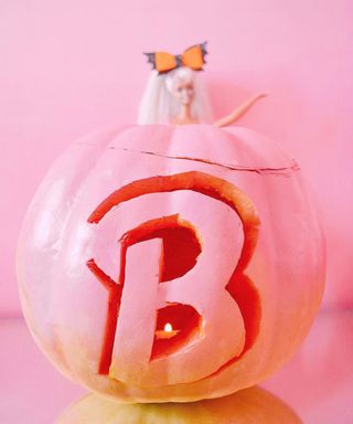 A pink pumpkin decorating idea with stencilled Barbie 'B' logo