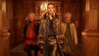 From left to right: Velementov (Douglas Hodge), Peter (Nicholas Hoult) and King Hugo (Freddie Fox) walking down a hallway in Season 3 of The Great.