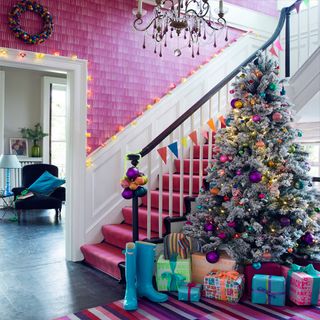 pink stairway with christmas tree and gift boxes