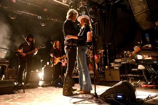 usician Duff McKagan (center left) and Susan Holmes-McKagan (center right) performs onstage at El Rey Theatre on June 13, 2019 in Los Angeles, California