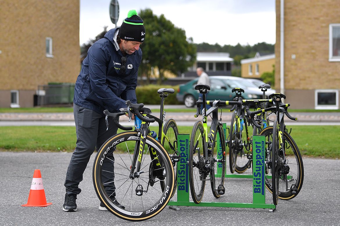 An Orica-Scott mechanic gets the rider's bikes ready