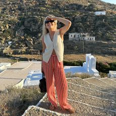 fashion influencer Lucy Williams in Europe wearing striped trousers and Havaianas