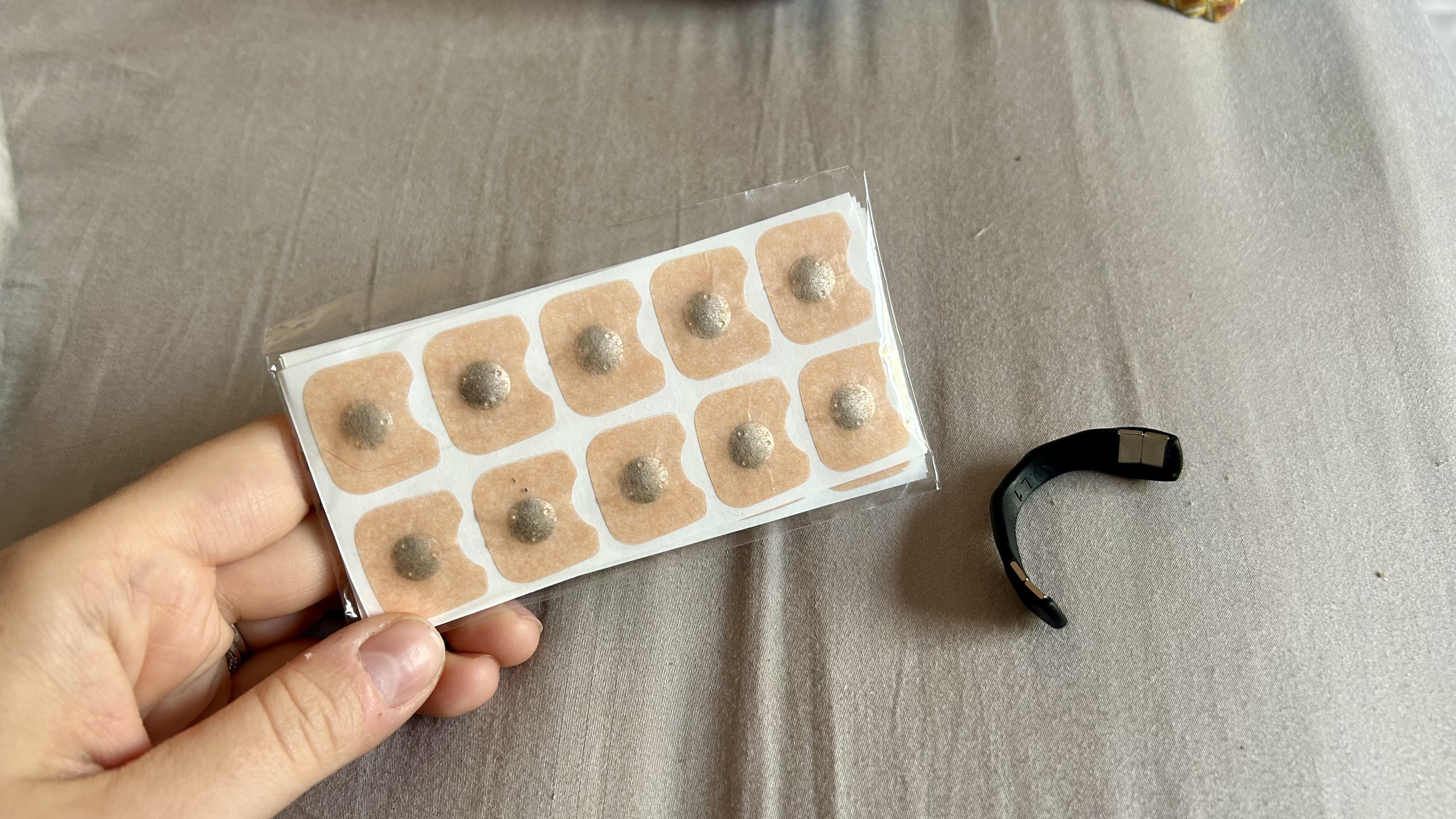 Holding the magnetic stickers next to an Intake band