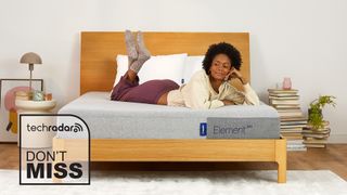 A woman lying on a Casper mattress with a deal logo in the background