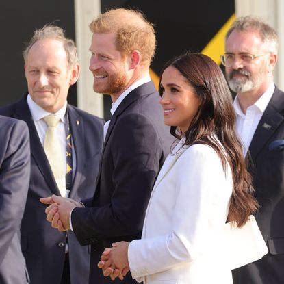 Prince Harry and Meghan Markle outside smiling