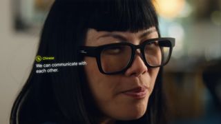 A woman wearing Google's AR translation glasses and seeing speech translated