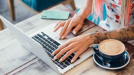 Person using a MacBook Air laptop.