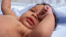 Baby rubbing eyes.