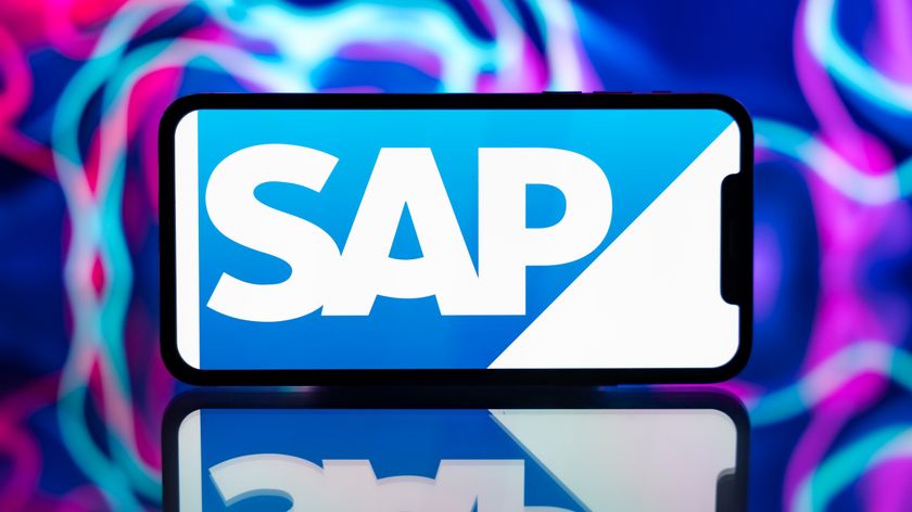 The SAP logo shown on a landscape phone, which sits on a reflective surface against a background of purple, blue, pink, and red trails of light.