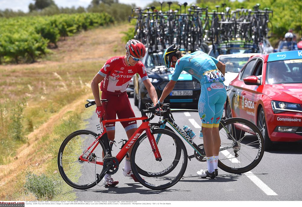 Jurgen Van den Broeck and Luis Leon Sanchez recover from a crash during stage 11 at the Tour de France.