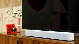 Sonos Beam soundbar in white colourway on wooded desk