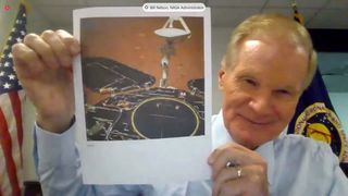 NASA Administrator Bill Nelson holds up a photo of China's Zhurong Mars rover during a House hearing on May 19, 2021.