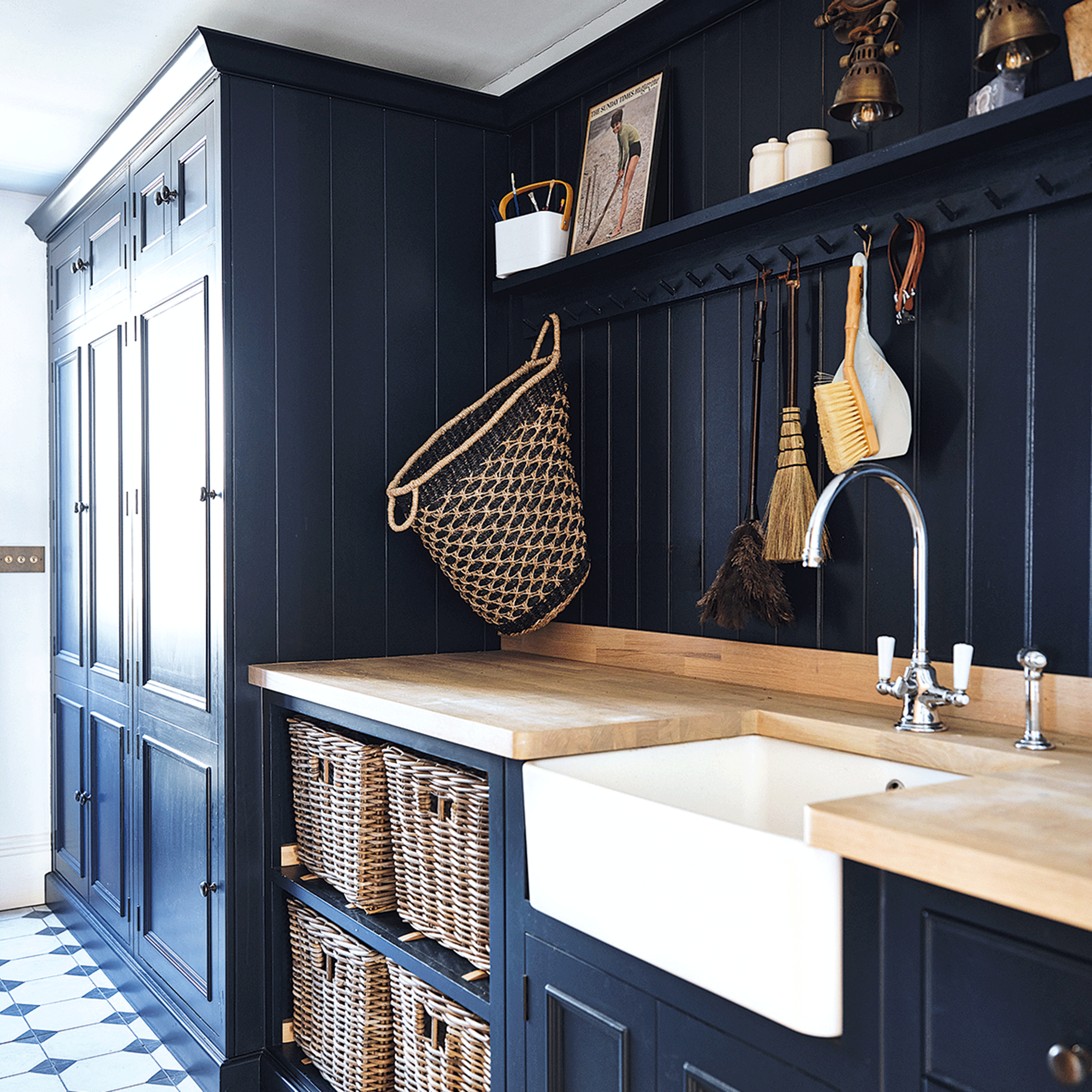 Navy blue utility room with white sink