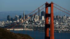 The skyline of San Francisco is seen behind the Golden Gate Bridge.