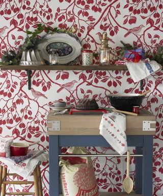Kitchen Christmas decor ideas with red and white printed wallpaper, and red and blue accents across the decor and kitchenware