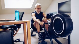 Man using rowing machine in a home