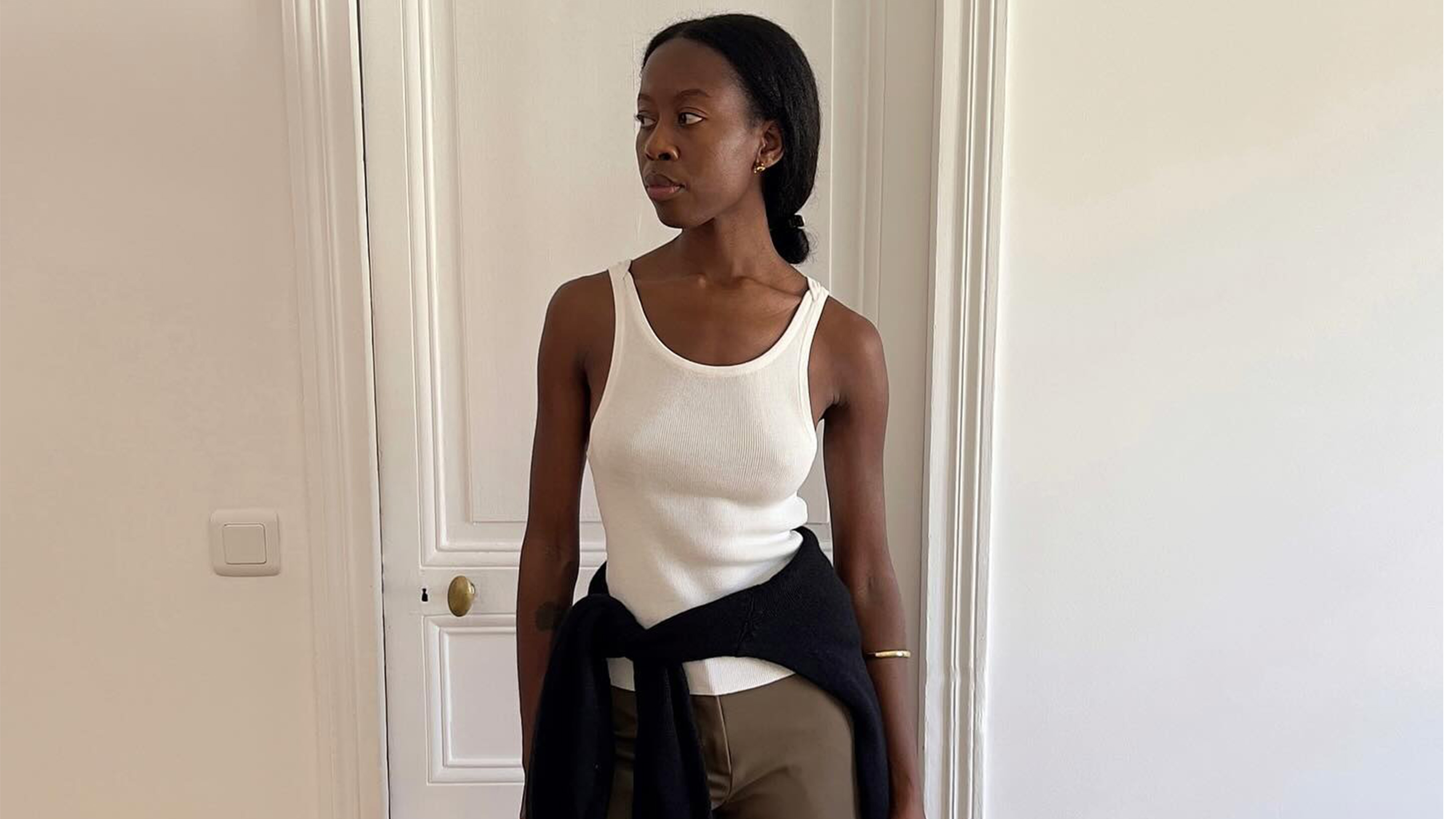 Sylvie Mus wearing a white tank top.