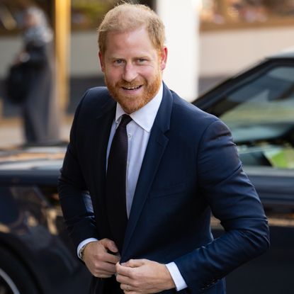 Prince Harry wearing a suit and smiling