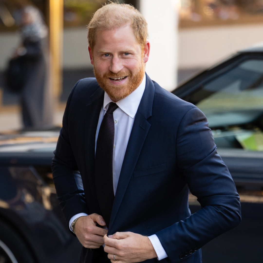 Prince Harry wearing a suit and smiling
