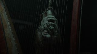 Walker head playing the harp in The Walking Dead: Daryl Dixon