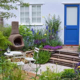 small cottage garden with sunken area with stove and seating