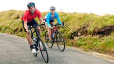 Couple cycling on country road