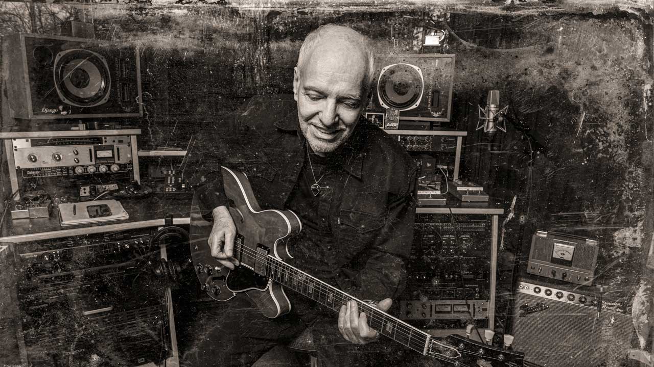 Peter Frampton with guitar (studio portrait)