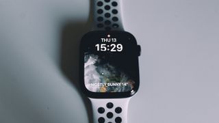 A close up of the Apple Watch series 8 screen against a white surface.