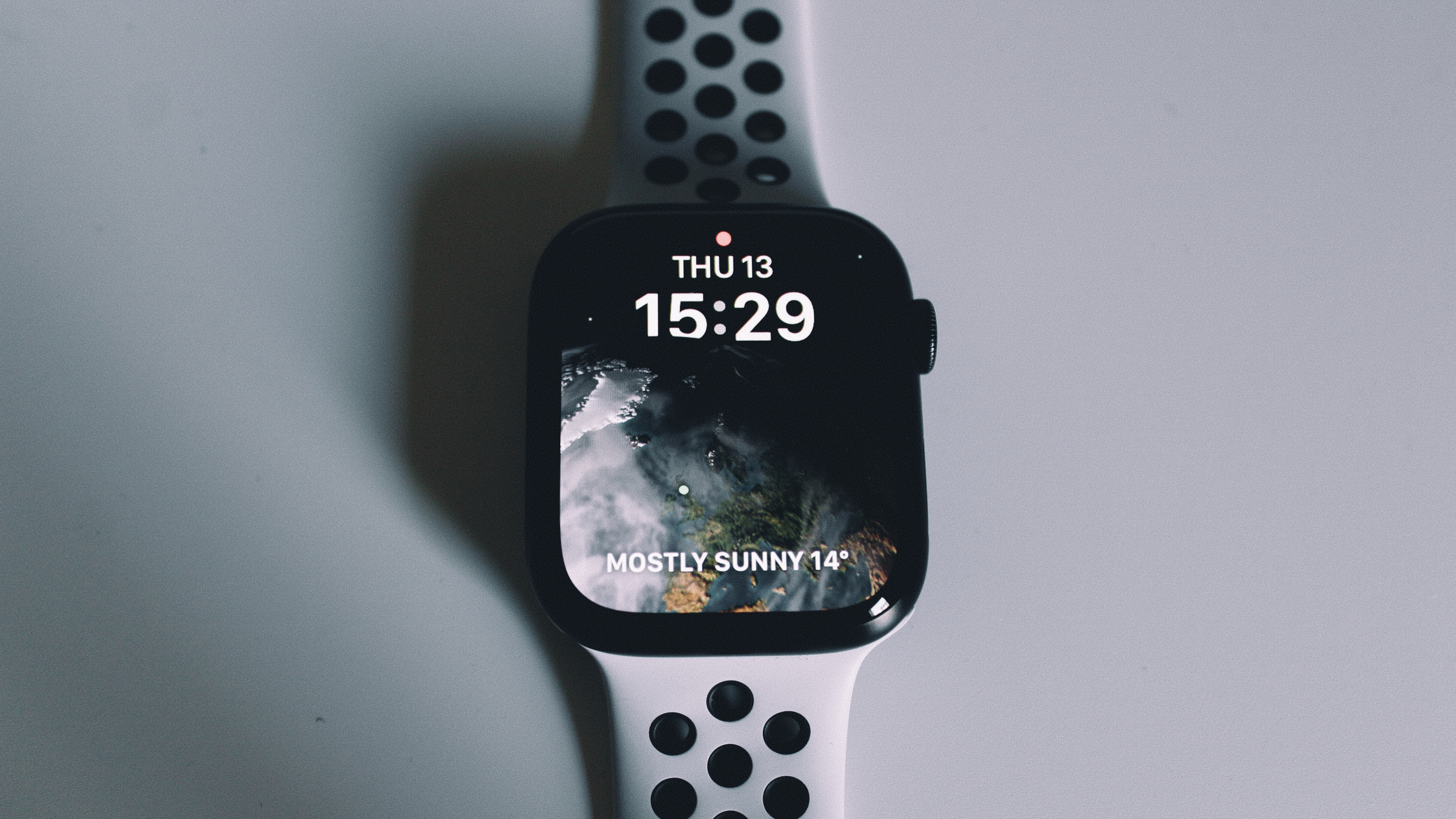 An Apple Watch series 8 on a gray table.