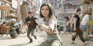 Alita: Battle Angel Alita stands in fighting stance, with Hugo running up from behind