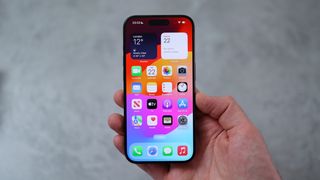 A photo of the iPhone 15 Pro being held by the reviewer