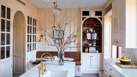 A warm neutral kitchen with curved details