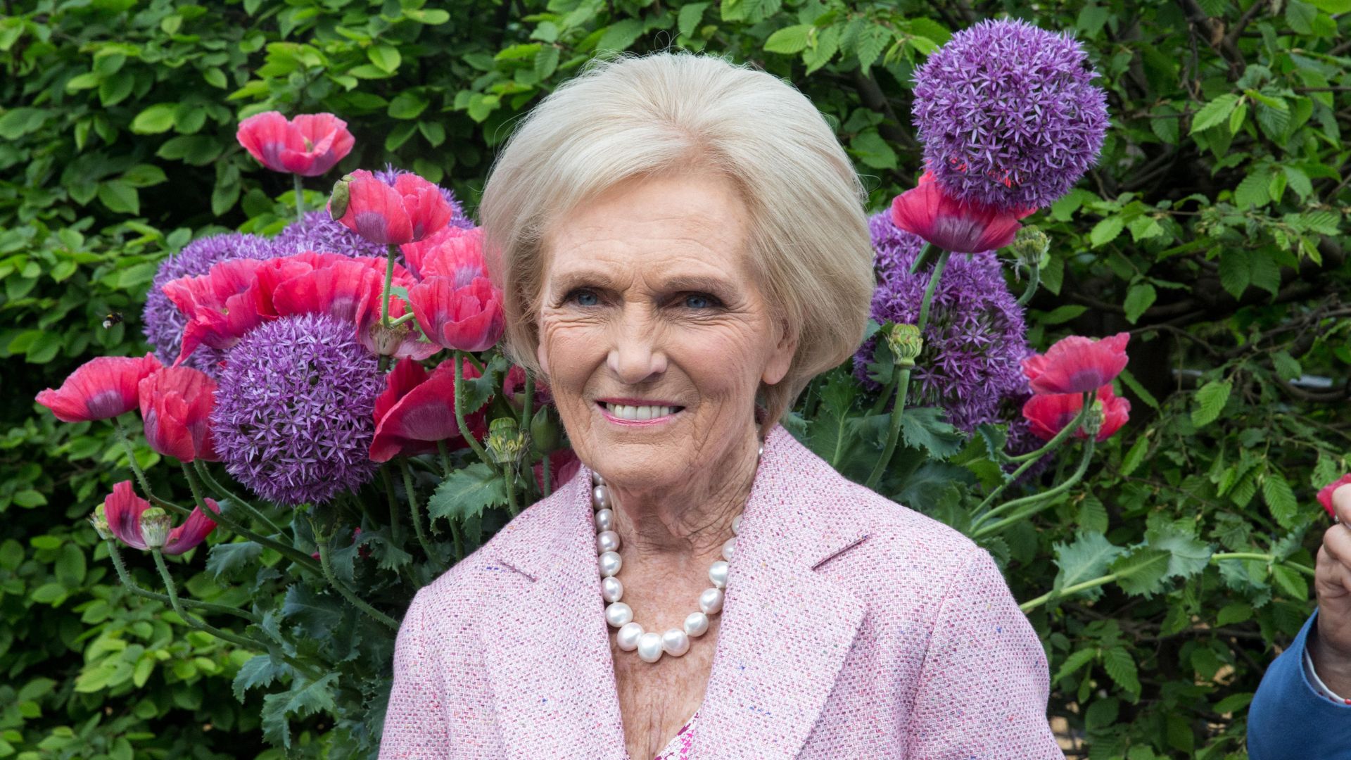 Mary Berry in front of some flowers