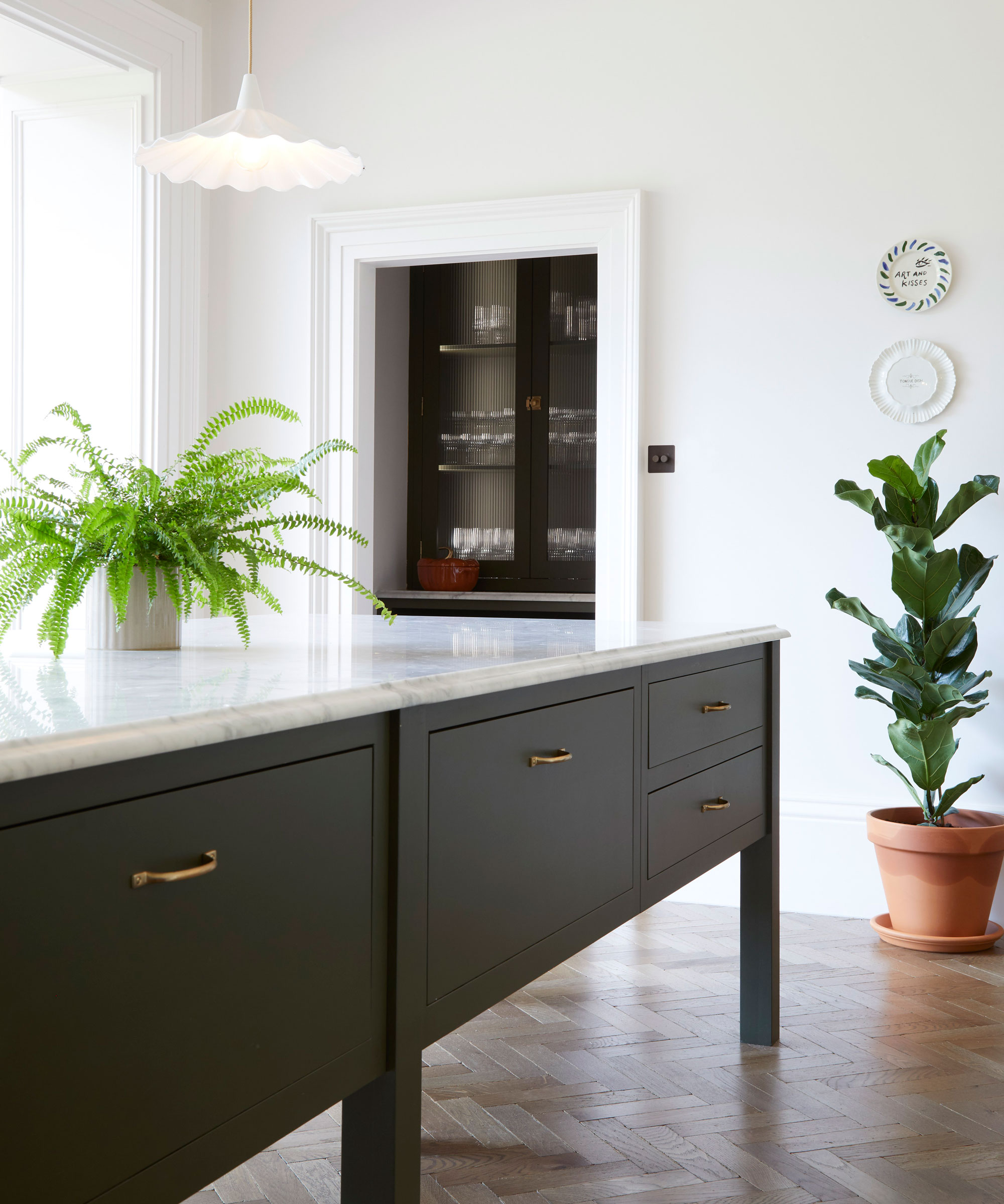 large black kitchen island with marble worktop